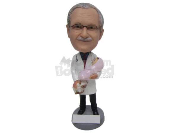 Custom Bobblehead Obyn Gynecologist Male Doctor In Medical Attire Holding A Baby In One Hand And A Teddy Bear In Other - Careers & Professionals Medical Doctors Personalized Bobblehead & Cake Topper